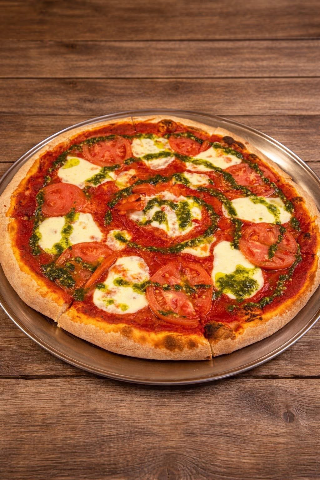 Margherita pizza with fresh tomato, mozzarella and basil pesto